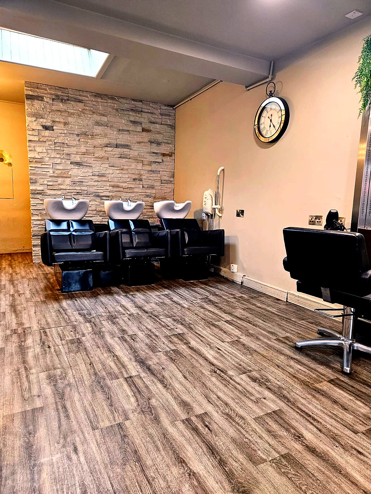 Honey Browns hair salon wash area — three sinks with stone feature wall, Ballincollig